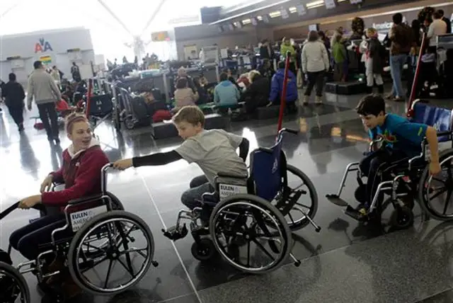Some kids try out wheelchairs to pass the time at JFK
